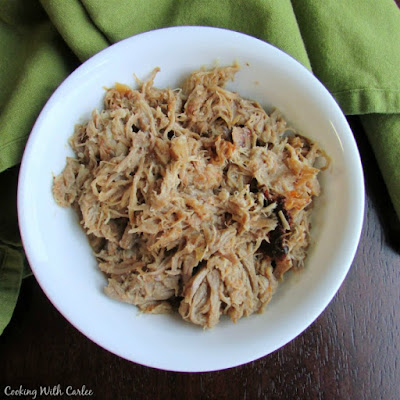 This pulled pork is a little bit teriyaki and a little bit char siu and all flavor! It is great on a sandwich and perfect over rice. Throw it in your slow cooker and dinner will be ready when you are! bowl of shredded pork with pineapple, ready to be made into sandwiches