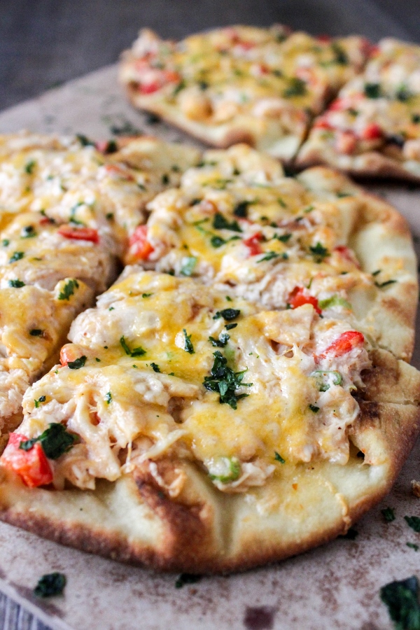 These rich and flavorful Red Chile Chicken Flatbread Pizzas come together quickly and are perfect for tailgating or as an easy weeknight meal!