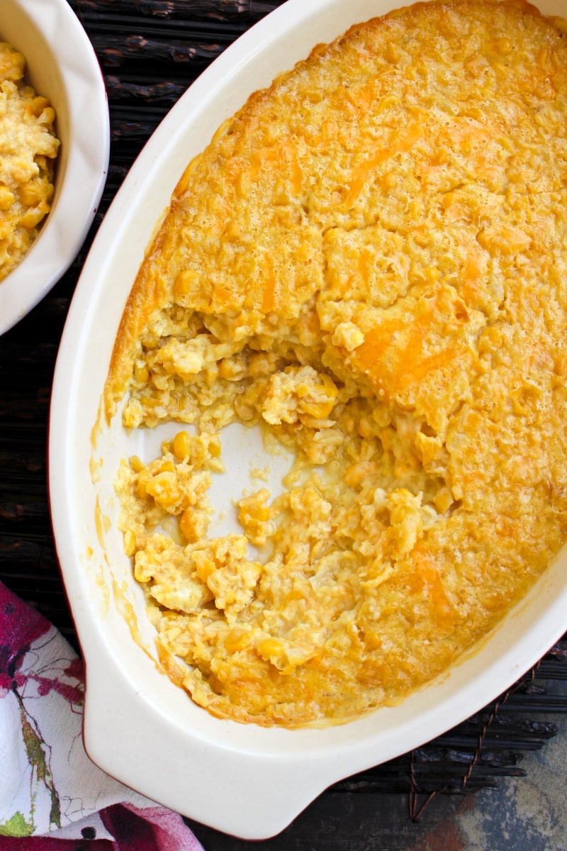 This Baked Creamed Corn is super easy to make and goes with any protein. It's easy enough to make on a weeknight and makes a great holiday side dish, too! #sidedish #cornrecipe