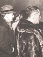 A photograph showing two men in profile.