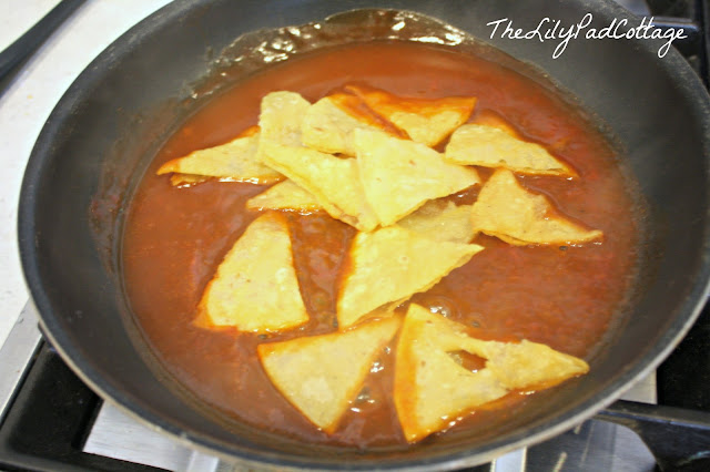 A bowl of soup on a metal pan on a stove