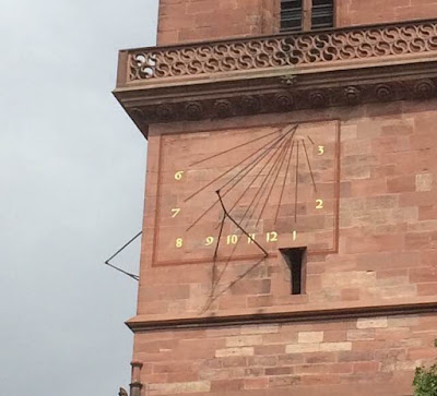Sun dial on old church along the Rhine