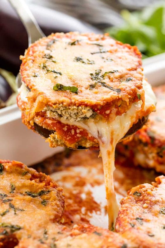 Delicious Baked Eggplant Parmesan with crispy coated eggplant slices smothered in cheese and marinara. #thestayathomechef #bakedeggplantparmesan #eggplantparmesan #eggplant #vegetarian