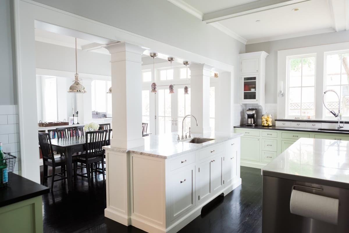 Modern farmhouse kitchen and breakfast area with black floors on Hello Lovely Studio