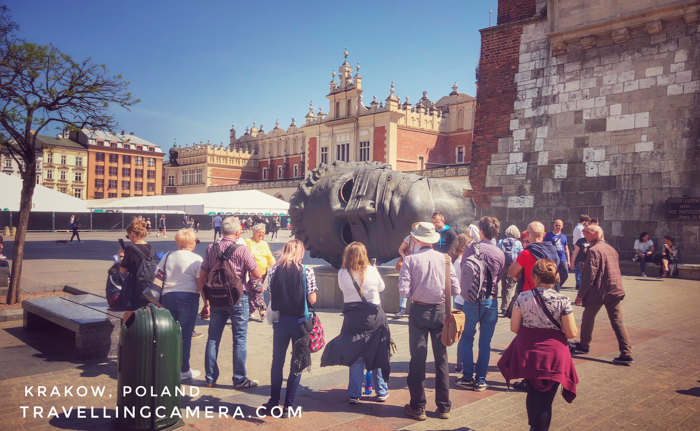 The giant head you see in above photograph is one of the main attractions outside the cloth hall and you can imagine the size of this head by looking at people around it and comparing sizes. It's called Eros Bound, which is build by Igor Mitoraj.     More from Poland her