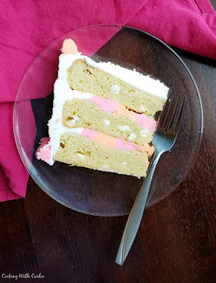 Special occasion cookies just went to the next level! Layers of cookie and plenty of frosting, making it perfect for a celebration! thin slice of layered cookie cake laying on a glass plate