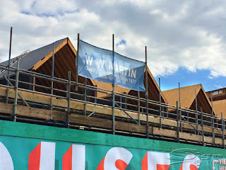 Blue Mesh banner WW Martin Quailty construction since 1877 on scaffolding in westbrook being blown by the wind.