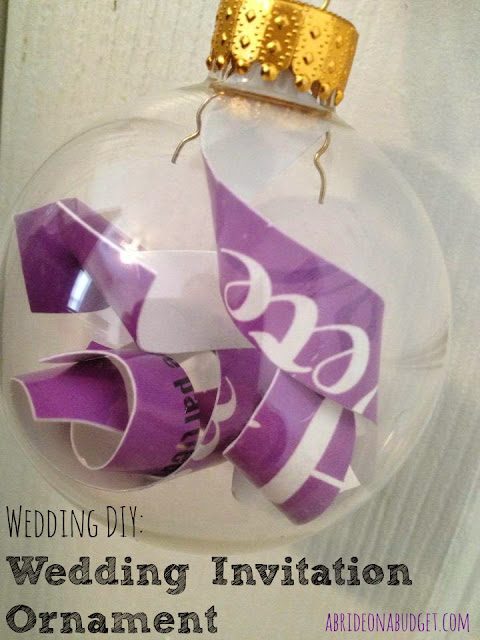 Looking for something festive to do with your wedding invitation? Turn it into a DIY Wedding Invitation Ornament with this tutorial on www.abrideonabudget.com.