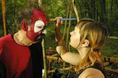 Applying makeup to horror clown 