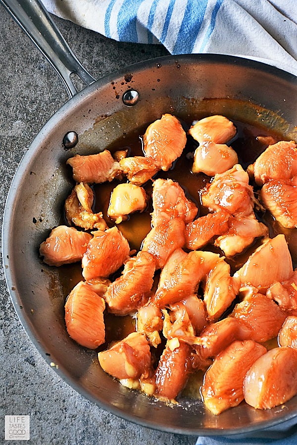 Searing chicken in a skillet for Teriyaki Chicken Rice Bowl