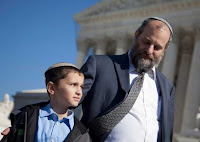 Ari Zivotofsky, right, stands with his nine-year-old son, Menachem, outside the Supreme Court in Washington, Monday, Nov. 7, 2011.
