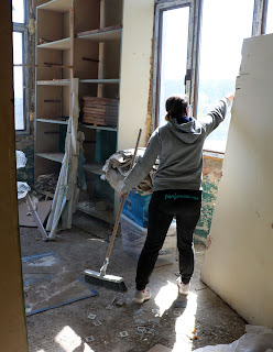 A opening a window before starting to sweep up A opening a window before starting to sweep up