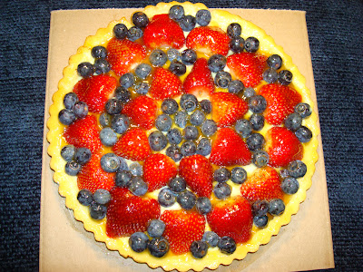 STRAWBERRY AND BLUEBERRY TART WITH PASTRY CREAM FILLING PORTIONS: 12 INGREDIENTS TART SHELL                                  ½ cup confectioner sugar 1 ½ cups all purpose flour 1/4 lb. unsalted butter 2 egg yolks PASTRY CREAM FILLING 2cups milk 1 lemon zest 1 tsp. vanilla extract 7 egg yolks 2/3 cups sugar 4 tbsp flour 1 tbsp. Caribbean coconut Rum 2 tbsp. unsalted butter FRUIT 12 - 14 Strawberries  1 cup blueberries, cut in half GLAZE 2 tbsp. lemon juice 2 tbsp. orange juice 1 tbsp. Quincy preserve 1/4 cup sugar PREPARATION FOR TART SHELL In the food processor combine, sugar, flour, butter and egg yolks. Mix just enough to be able to form a ball. Place the dough in refrigerator for half  hour. In a tart pan, about 10" in diameter and removable bottom, extend the dough, pressing with your fingers at the bottom and to the sides of the pan. Make sure you press well against the indentations of the tart pan. Cook the tart in a preheated oven at 350° F - 176° C for about 13 minutes, lightly browned. Let it cool. PREPARATION OF THE PASTRY FILLING Heat up the milk almost to the boiling point. Beat together in a bowl the egg yolks, sugar, lemon zest, vanilla extract ,flour and coconut Rum. Very slowly add the milk to the egg yolk mix stirring continuously. Put back in the pan the milk and egg yolks mix. At low flame and constantly stirring let the pastry sauce to thicken . Cook for about 3 more minutes after it thickens.  Stir in the butter and cover with a wrap to prevent a skin forming on top. Let it cool off completely and refrigerate it. PREPARATION OF THE GLAZE In a small pot, dissolve the Quincy preserve, the sugar with the lemon juice and orange juice. Let  reduce the liquid a bit. FINISHING THE TART Fill up the tart with the pastry filling, almost to the edge. Arrange the fruit over the custard, and glace it.