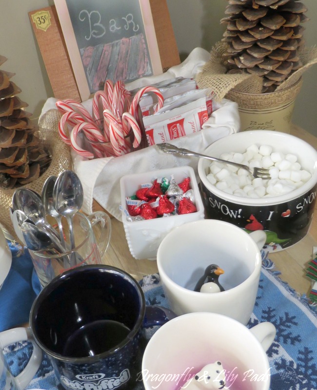 Bright and cheery Hot cocoa bar done in blue white and snow theme.