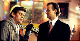 Bill Murray talking to a taxi driver in Scrooged 1988 movieloversreviews.filminspector.com
