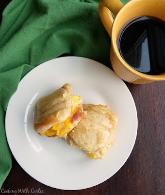 Breakfast sandwiches are one of life's simplest pleasures. The ingredients are affordable and simple. There really isn't much technique involved and they results are perfectly delicious. There is just something about salty meat, soft eggs and gooey cheese that make the perfect filling for a sandwich! sliders with scrambled eggs, ham and cheese with cup of coffee