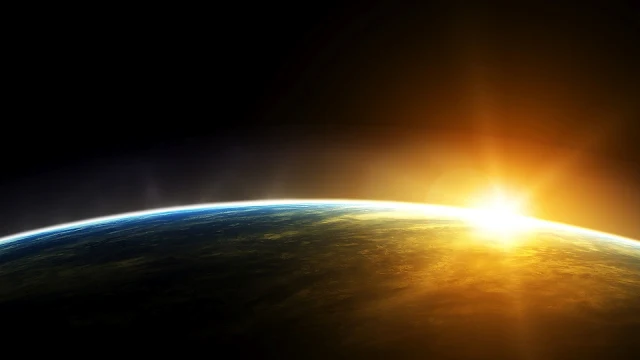 De Aarde en een opkomende zon