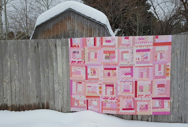 pink log cabin quilt on fence