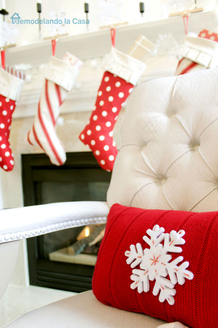Christmas pillow with a red sweater and snow flake on it