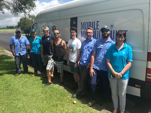 Members of the research and field operations team in front of the Mobile Mosquito Unit