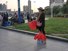 woman selling PRC flags in Mudanjiang, China