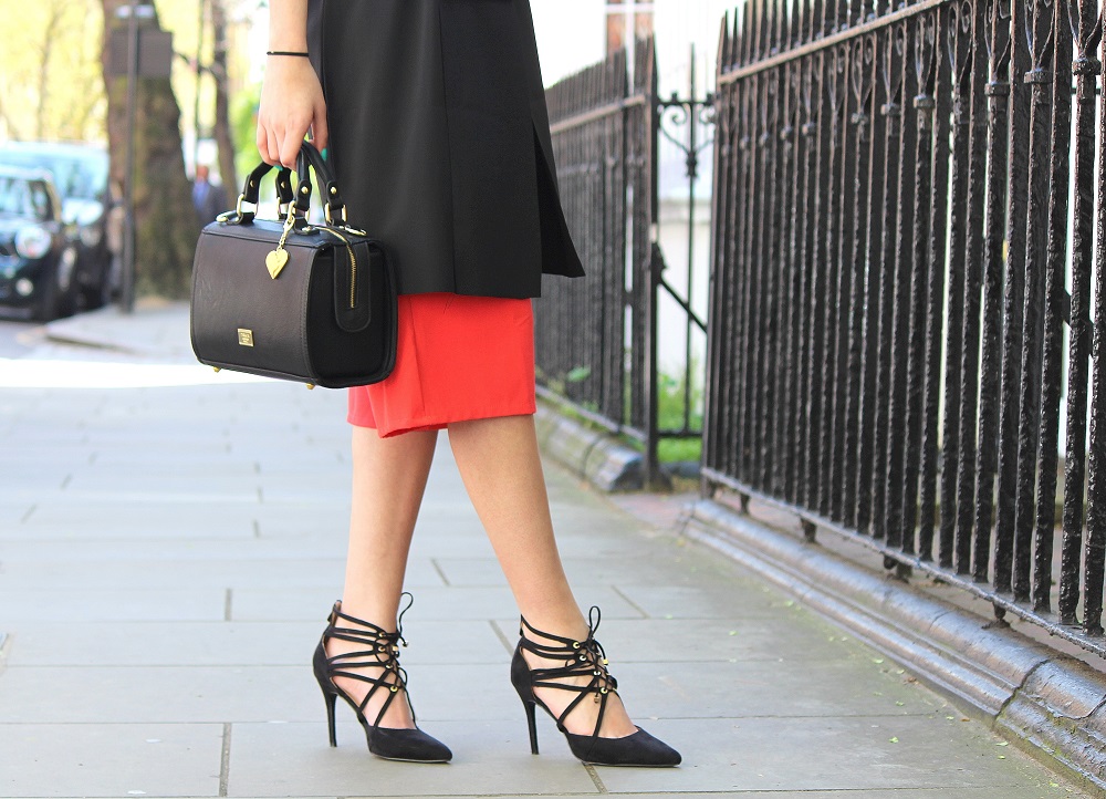 peexo fashion blogger wearing culotte jumpsuit and sleeveless blazer and black box bag and lace up heels in spring
