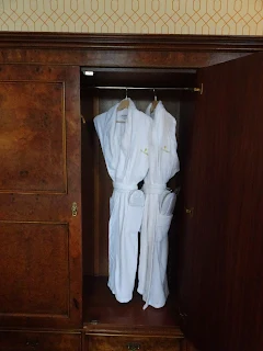 robes hanging in antique wardrobe