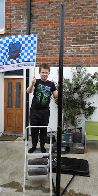 basketball hoop stand used as flagpole for scouts group
