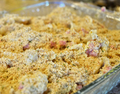 chicken cordon bleu casserole covered in a seasoning in a pan