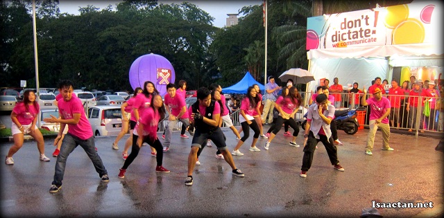 A flash mob outside Stadium Merdeka dancing in the rain