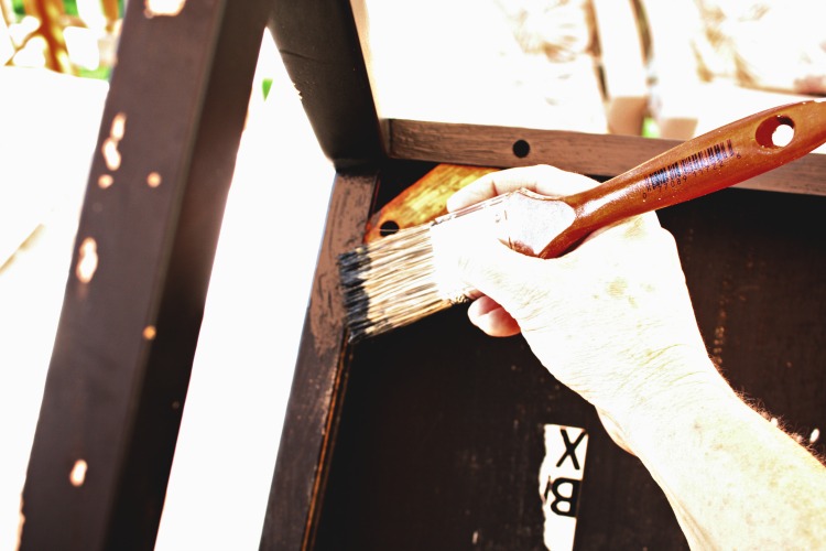 Begin painting by turning the chair upside down. Turn chair upside down to paint.
