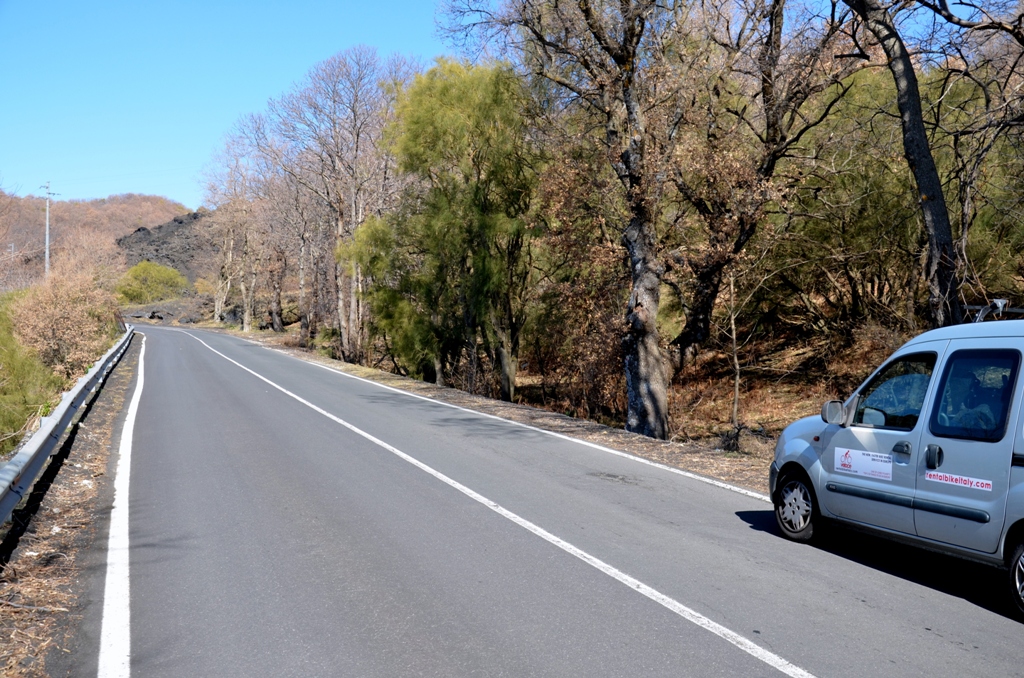 Team car during cycling exploration of Etna volcano