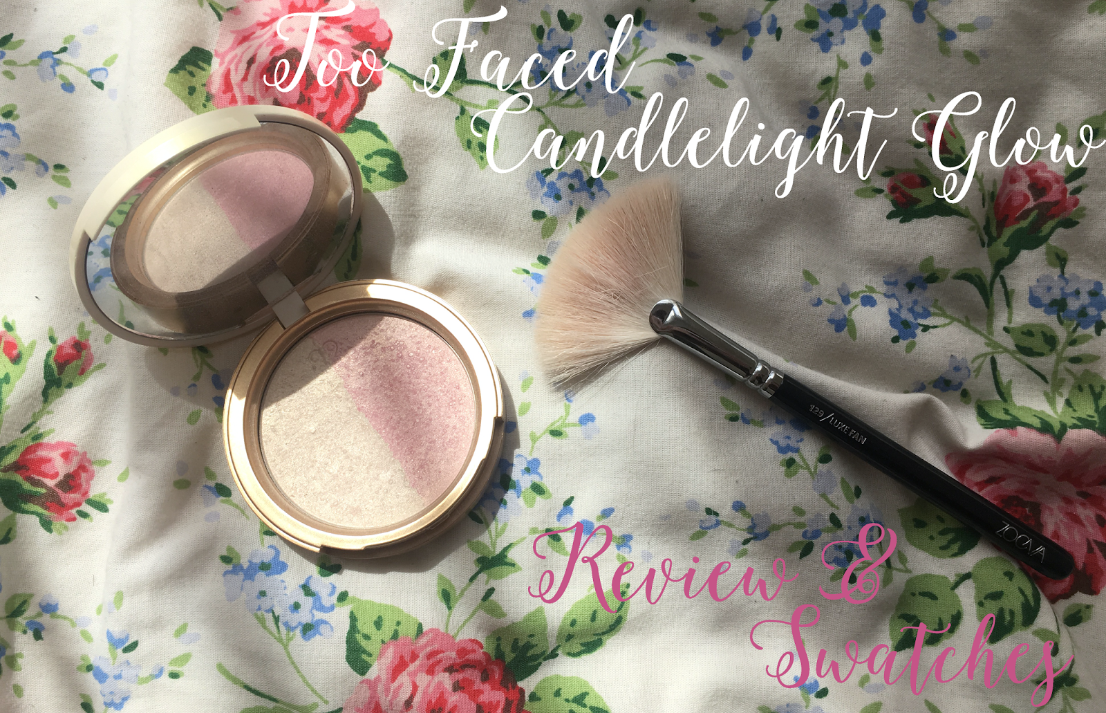 too faced candlelight rosey glow lying on a bed next to the zoeva fan brush 