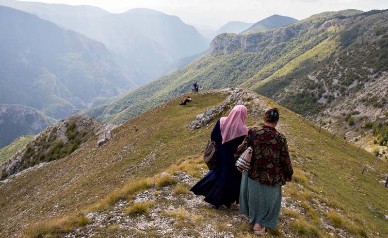 Women take in the view of the slopes of Bjelašnica mountain near Lukomir.