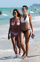 Nicole Murphy walking on the beach with a friend