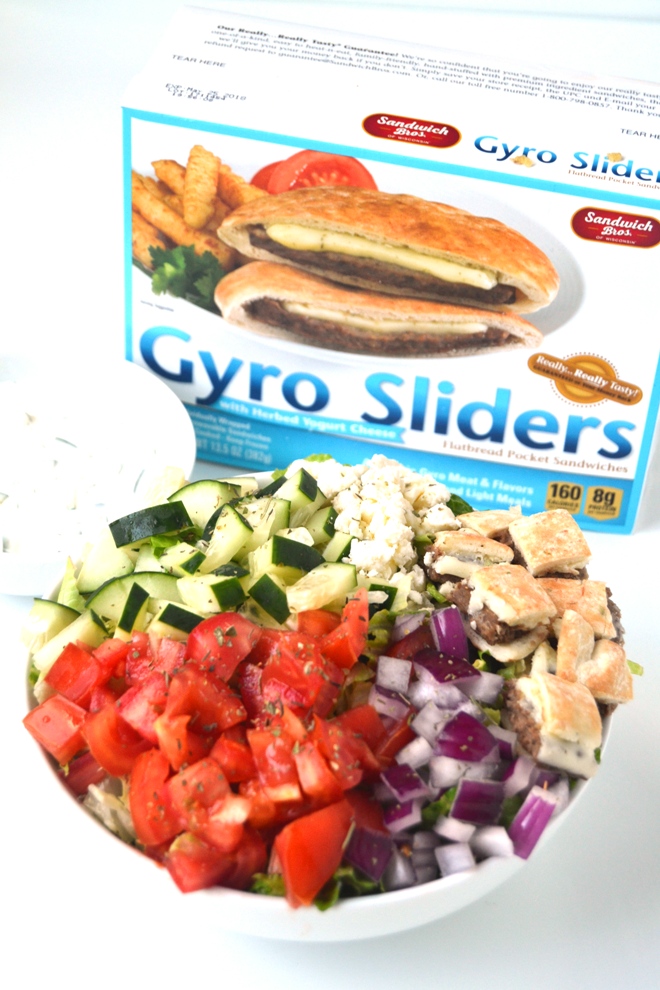 Gyro Salad with Tzatziki takes just 10 minutes to make and is loaded with tomatoes, cucumber, gyro sliders, red onion, feta cheese and is topped with homemade tzatziki sauce. www.nutritionistreviews.com