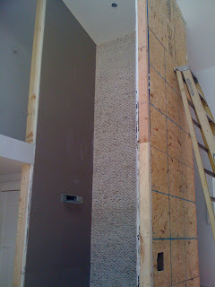 Construction photo of the two story shower by Studio Santalla