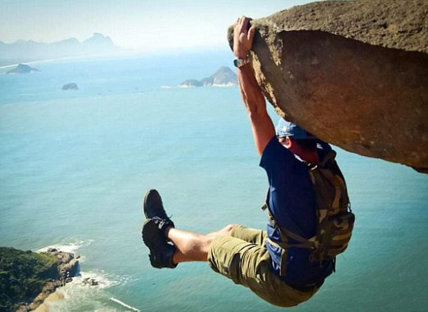 This is Luis Fernando Candela. He claims to have prepared for this moment for months at the gym. The rock he's hanging from is 984 feet above the beach. - This Viral Photo Inspired Copycats, But There’s Something You Should Know… This is Luis Fernando Candela. He claims to have prepared for this moment for months at the gym. The rock he's hanging from is 984 feet above the beach. - This Viral Photo Inspired Copycats, But There’s Something You Should Know…