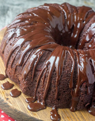 cherry fudge bundt cake with chocolate glaze drizzled over the top