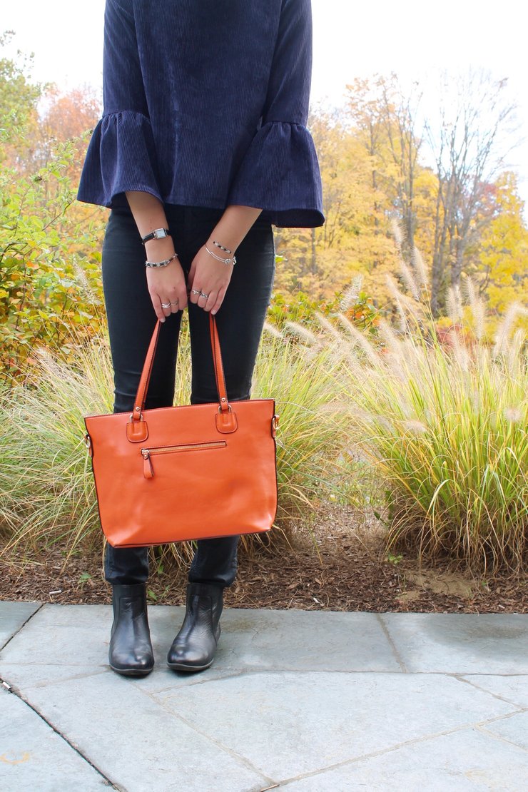 bell sleeve shirt, orange purse, black jeans for a cute Halloween outfit
