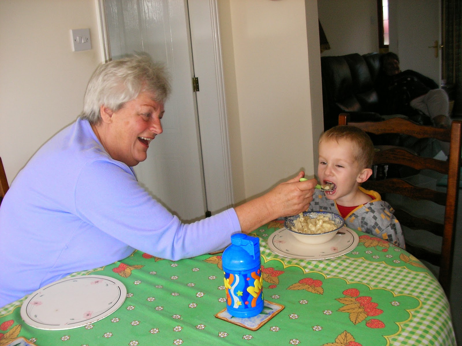 grandmother spoon feeds boy too old for this feeding the kid