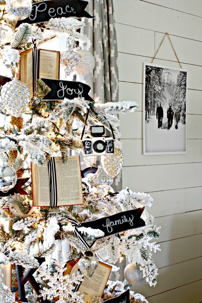 Flocked Christmas tree with black and white accents and book ornaments - www.goldenboysandme.com