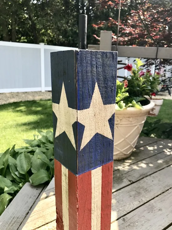 wooden firecracker for the fourth of July adding a fuse