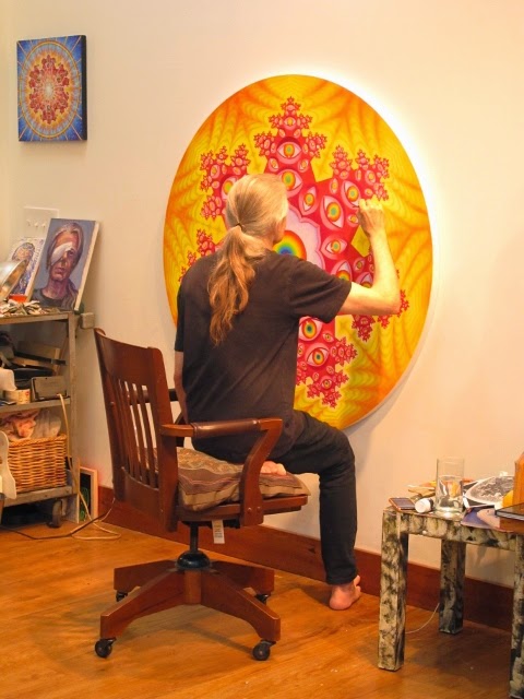 Alex Grey painting in his studio.