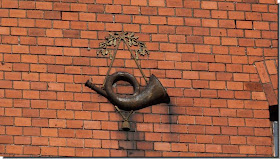 Remains German horn on building wall