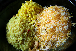 Rice, corn and cheese being added to the crockpot