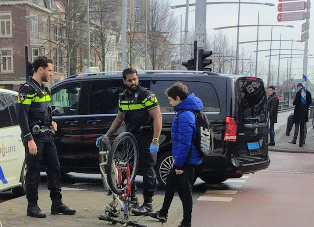 Police help repair a kid's bicycle Police help repair a kid's bicycle