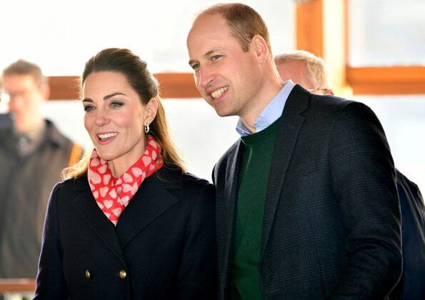 Kate Middleton wore a new navy coat by Hobbs London, and a new knitted puff-sleeve midi dress by Zara. Beulah London Kamala scarf