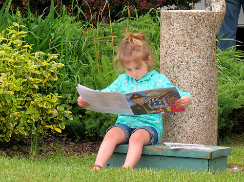 small girl reading a book
