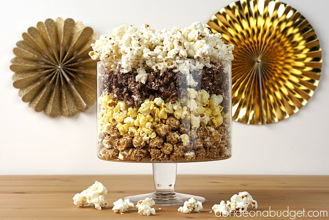 Thinking of a popcorn bar for your wedding? Figure out exactly what you need to do in this DIY Wedding Popcorn Bar post on www.abrideonabudget.com. #wedding #weddingplanning #actionstation #popcornbar #diywedding